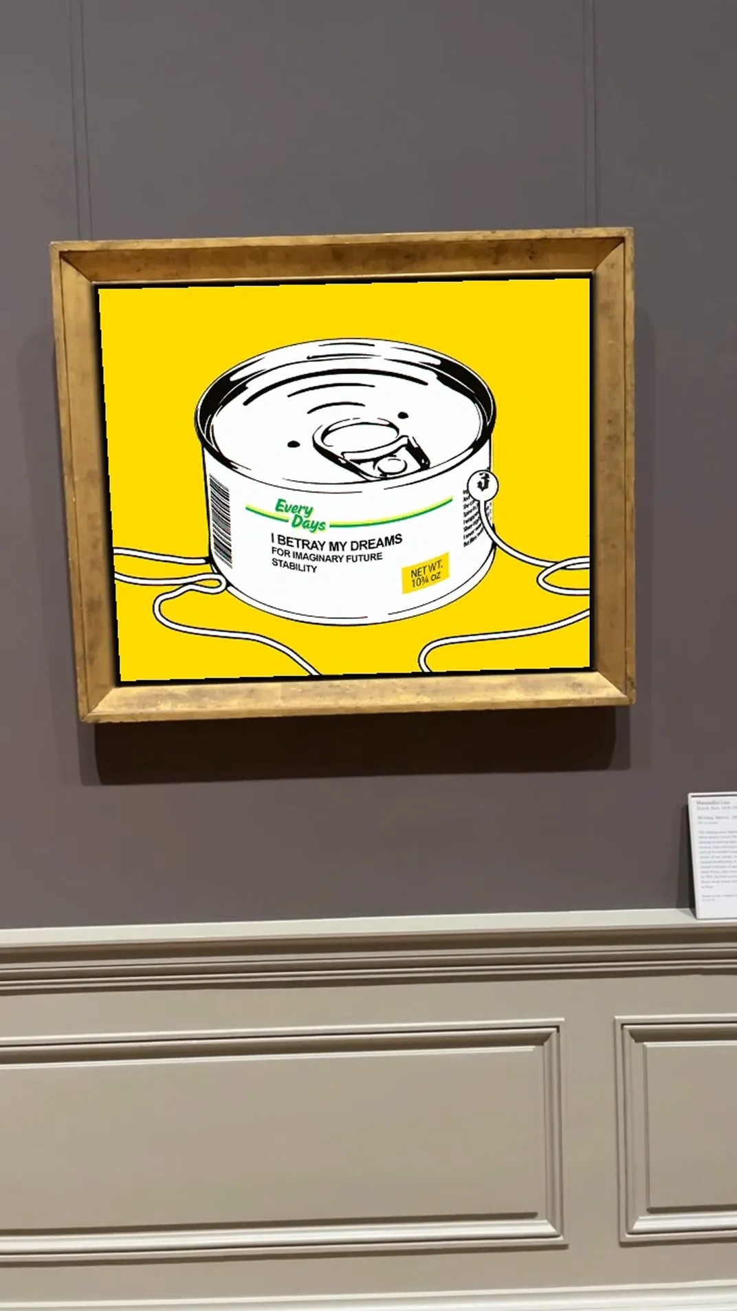 Yellow graphic art print with a canned-product illustration and the text I Betray My Dreams for Imaginary Future Stability